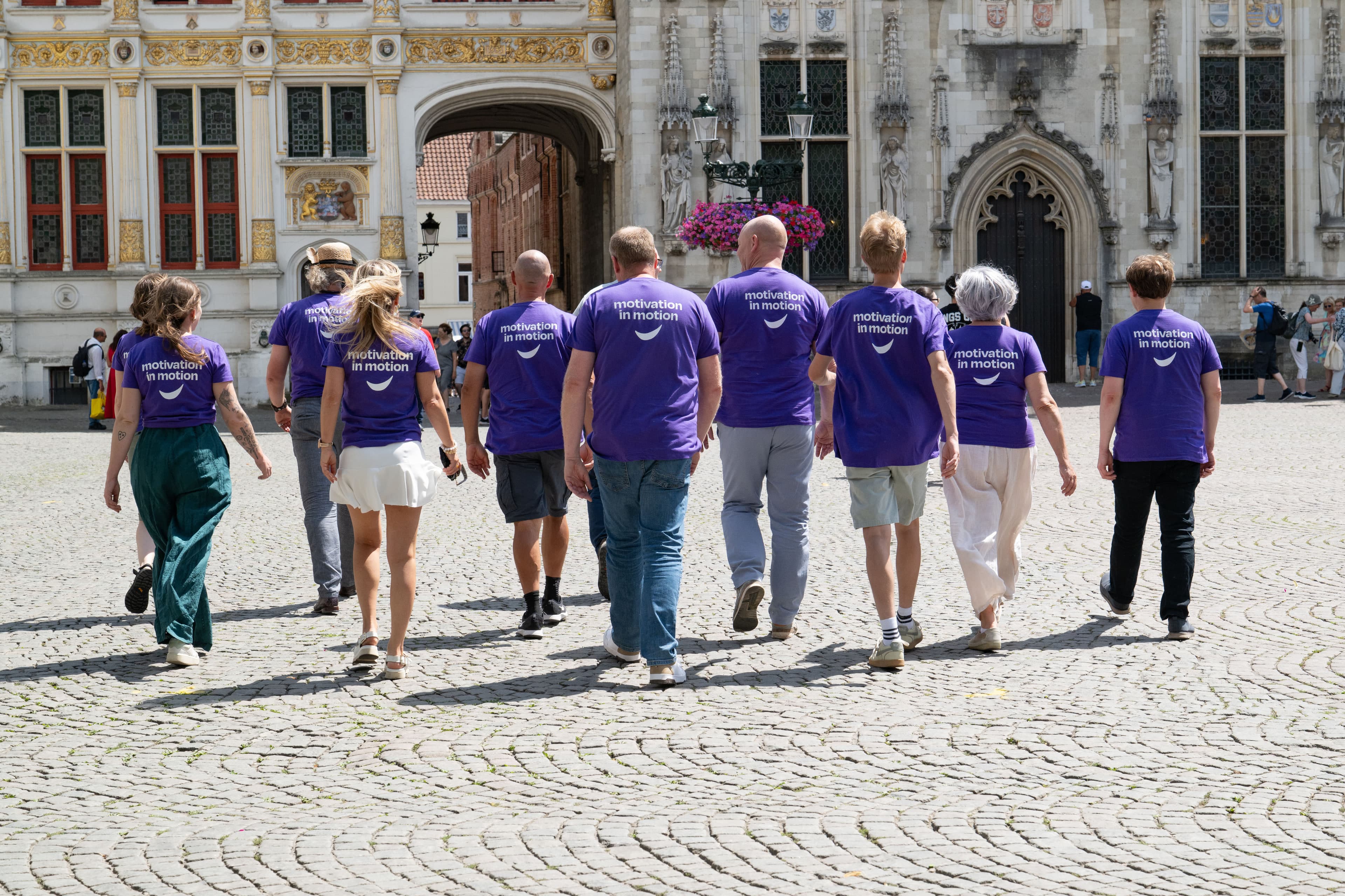 Motisha team walking through Bruges seen from the back