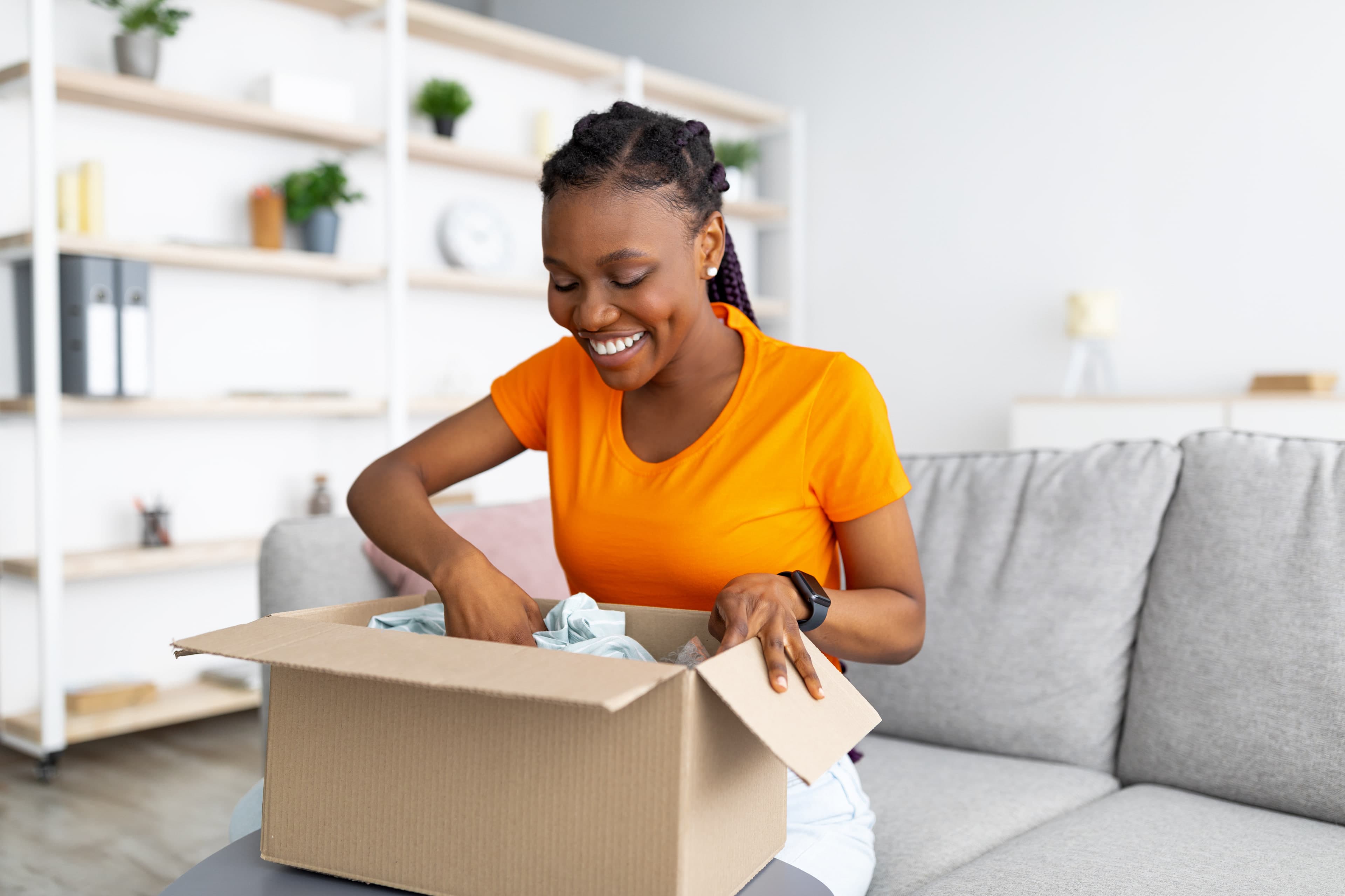 Smiling woman unpacking a reward delivered to her door